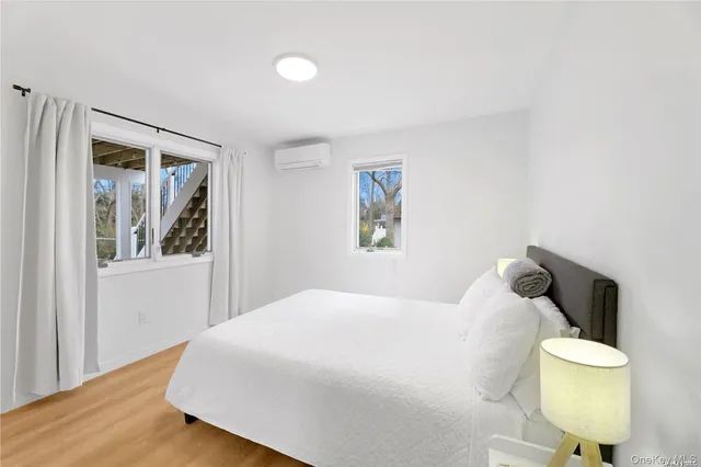 a bedroom with a bed and painting on the wall