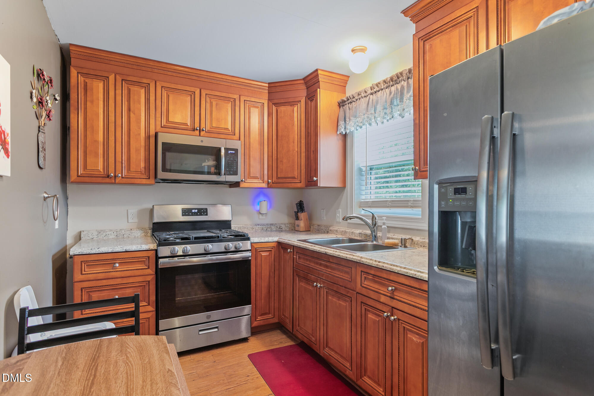 3163 Saul Loop Road Elon, NC 27244 - Photo 26 of 44 a kitchen with stainless steel appliances kitchen island granite countertop a stove a sink and a refrigerator