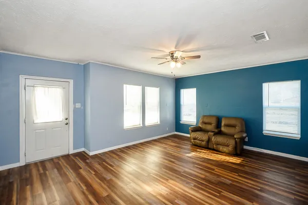a view of room with window chandelier fan and windows