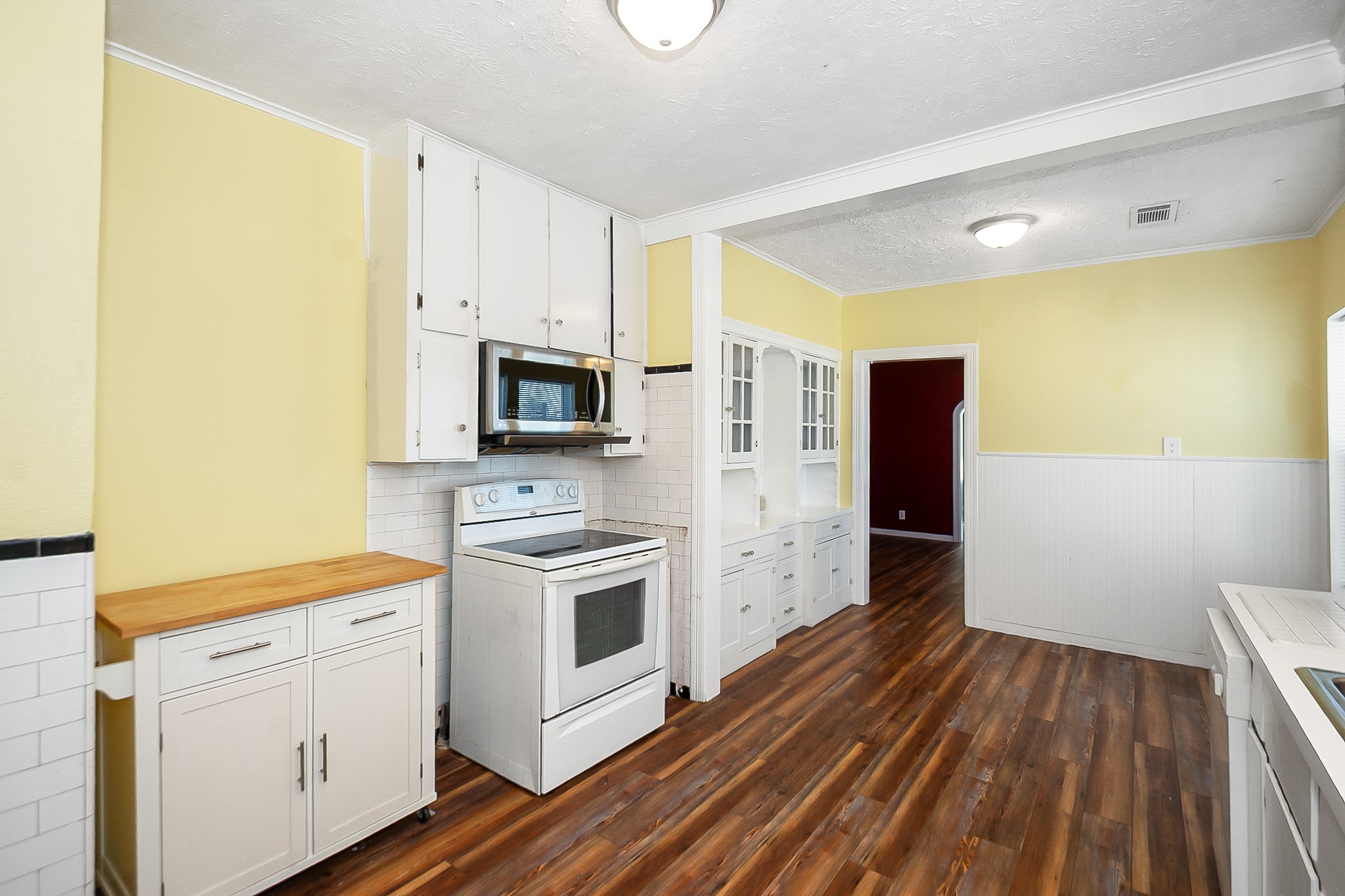 109 Maple Street Highlands, TX 77562 - Photo 20 of 50 a kitchen with a sink a refrigerator and cabinets