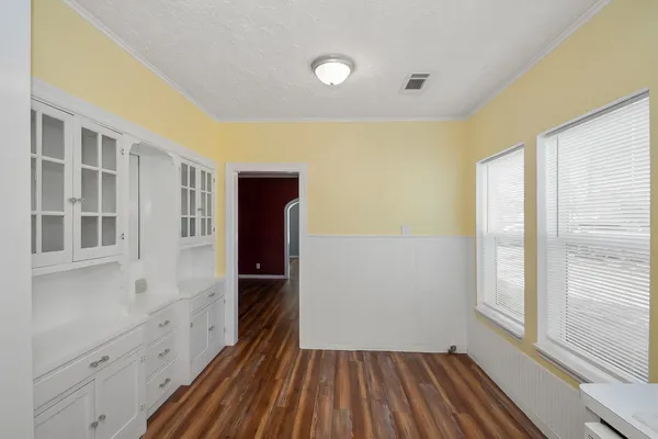a view of a room with wooden floor and windows