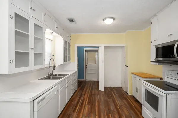 a kitchen with a sink and a stove top oven