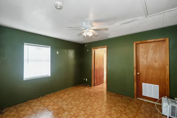 a bedroom with closet and window