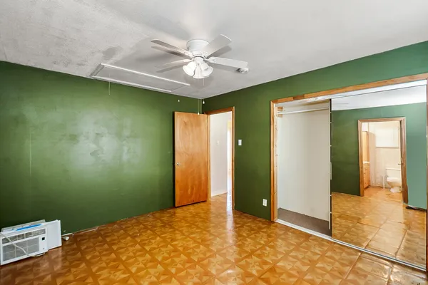 a view of a livingroom with a ceiling fan and a window