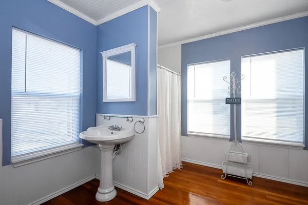 a bathroom with a sink a mirror and a window