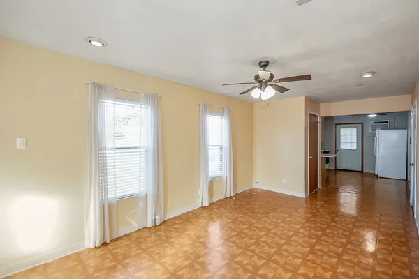 a view of a livingroom with a ceiling fan and window