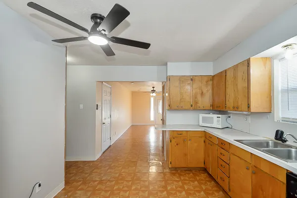 a kitchen with stainless steel appliances a sink cabinets and window
