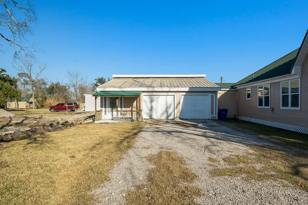 a view of a house with a yard and garage