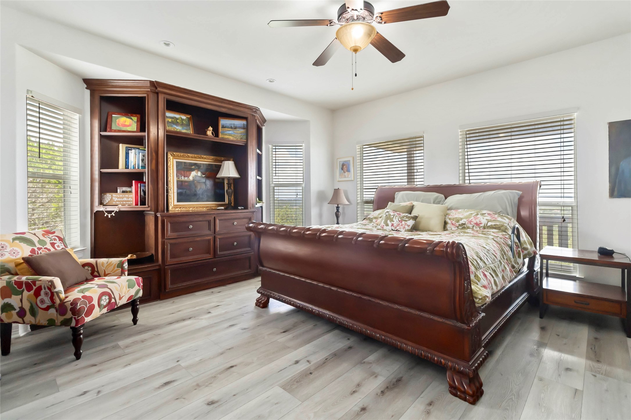 633 Flaman Road Canyon Lake, TX 78133 - Photo 15 of 40 a bedroom with a bed and wooden floor