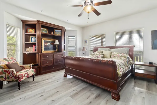 a bedroom with a bed and wooden floor