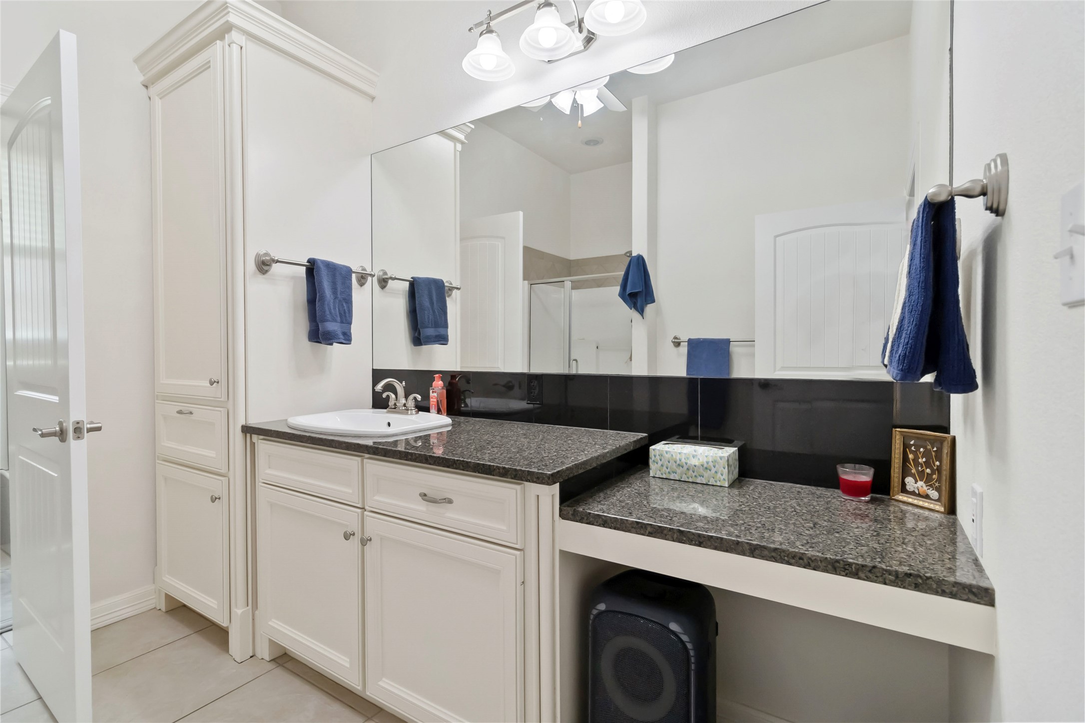 633 Flaman Road Canyon Lake, TX 78133 - Photo 24 of 40 a bathroom with a granite countertop sink a mirror and vanity