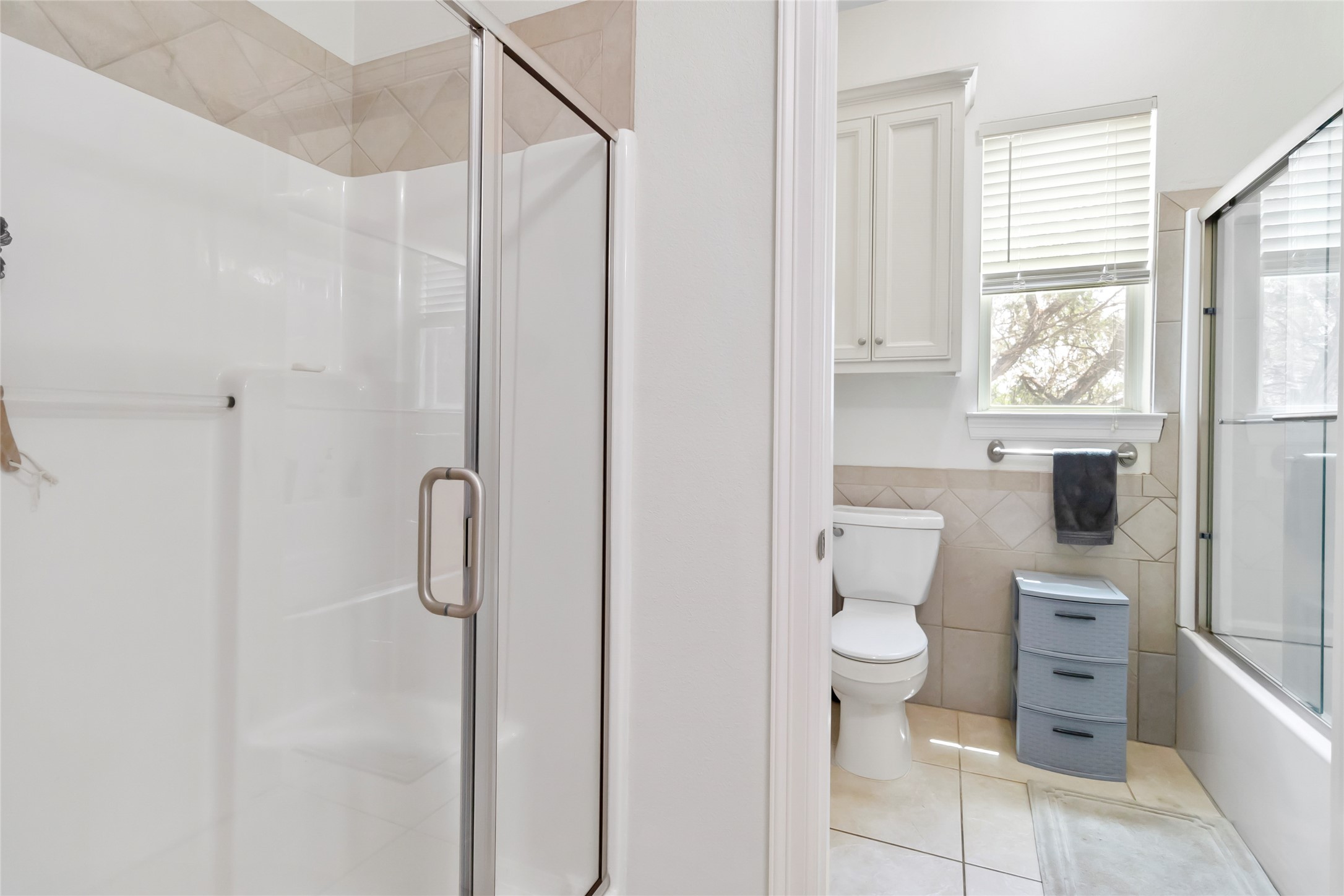 633 Flaman Road Canyon Lake, TX 78133 - Photo 25 of 40 a bathroom with a toilet sink and shower