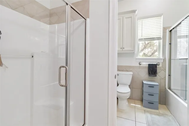 a bathroom with a toilet sink and shower