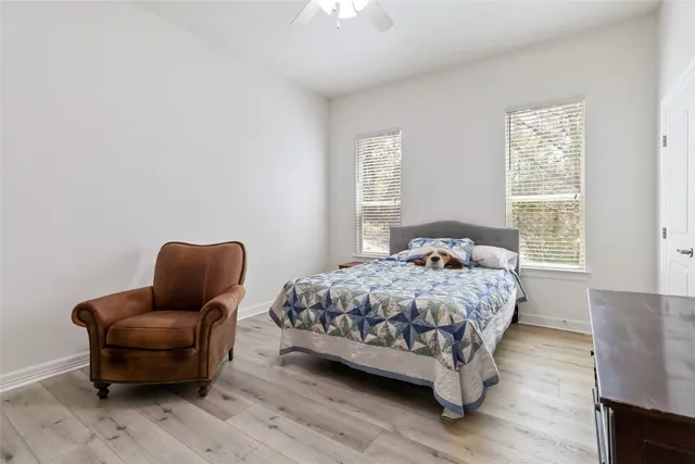 a bedroom with a bed chair and a window