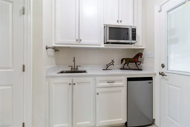 a kitchen with stainless steel appliances granite countertop a sink a microwave and cabinets