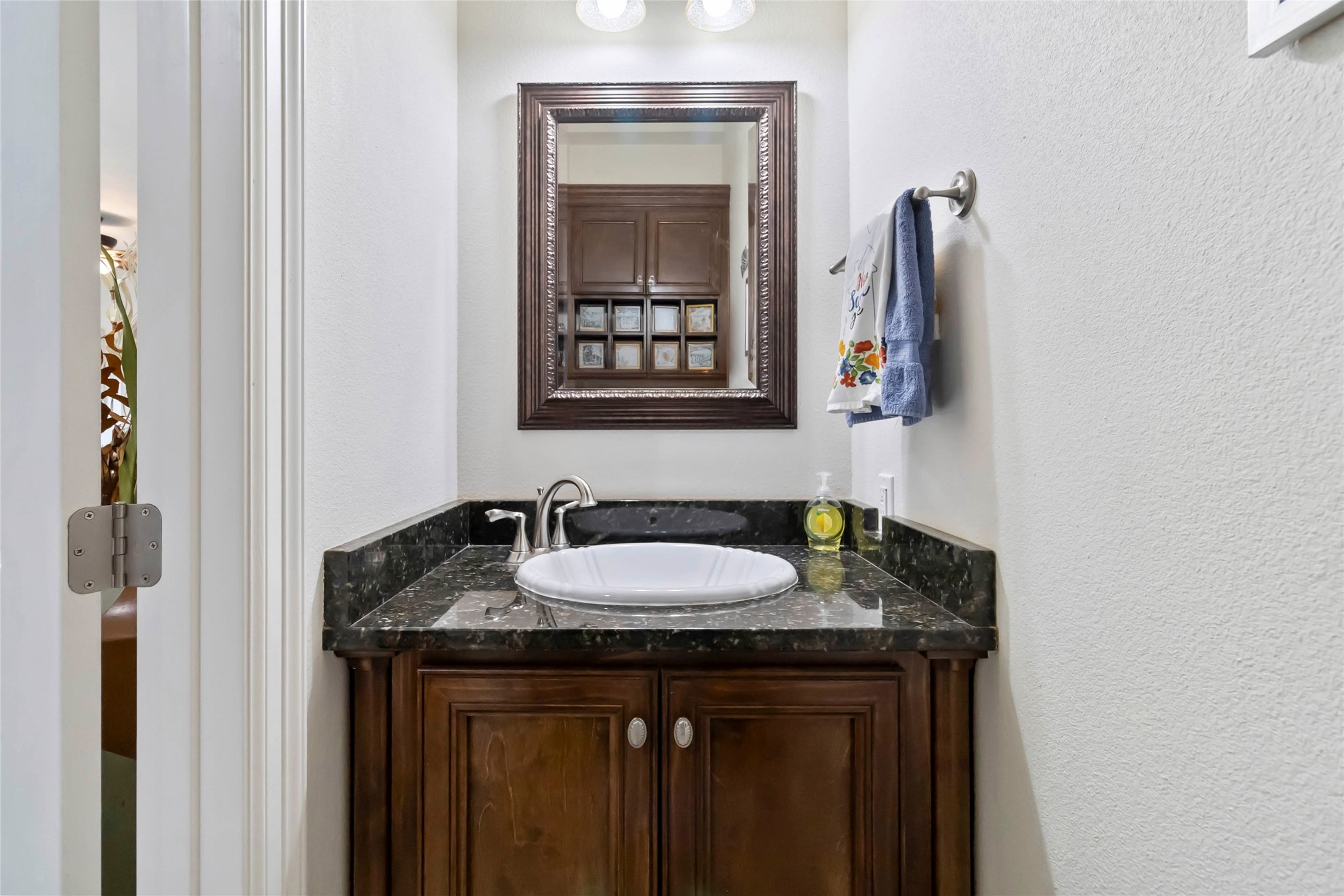 633 Flaman Road Canyon Lake, TX 78133 - Photo 28 of 40 a bathroom with a granite countertop sink and a mirror