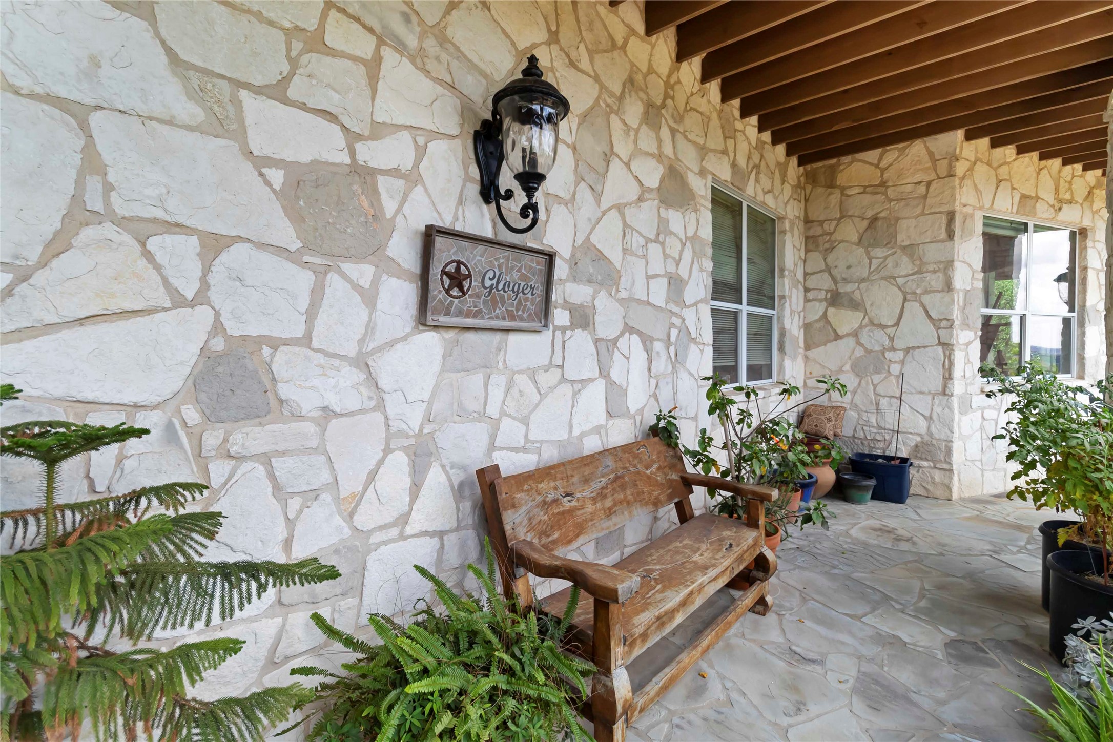 633 Flaman Road Canyon Lake, TX 78133 - Photo 35 of 40 a wooden bench sitting in front of a building