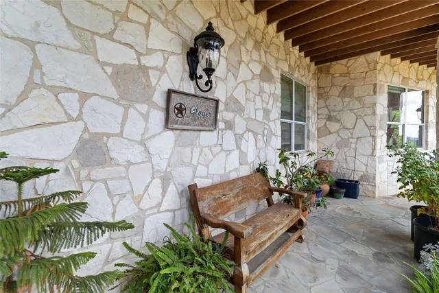 a view of a yard with wooden fence and large trees