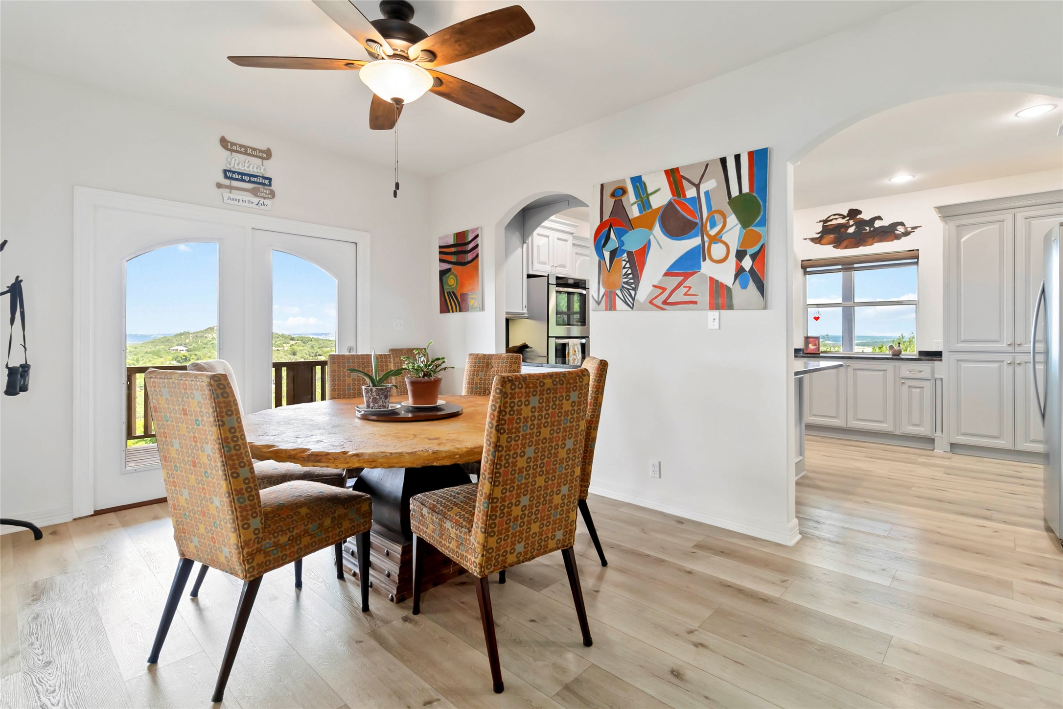 633 Flaman Road Canyon Lake, TX 78133 - Photo 9 of 40 a view of a dining room with furniture wooden floor and a chandelier fan
