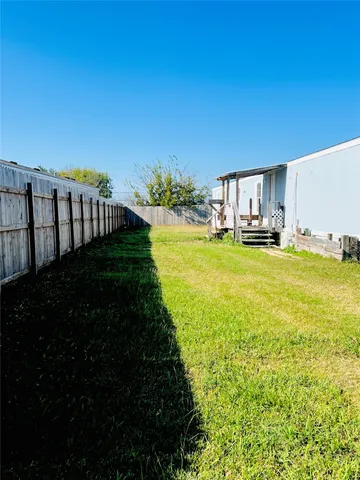 a view of a house with yard and deck