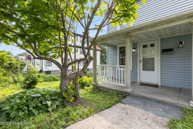 a front view of a house with garden