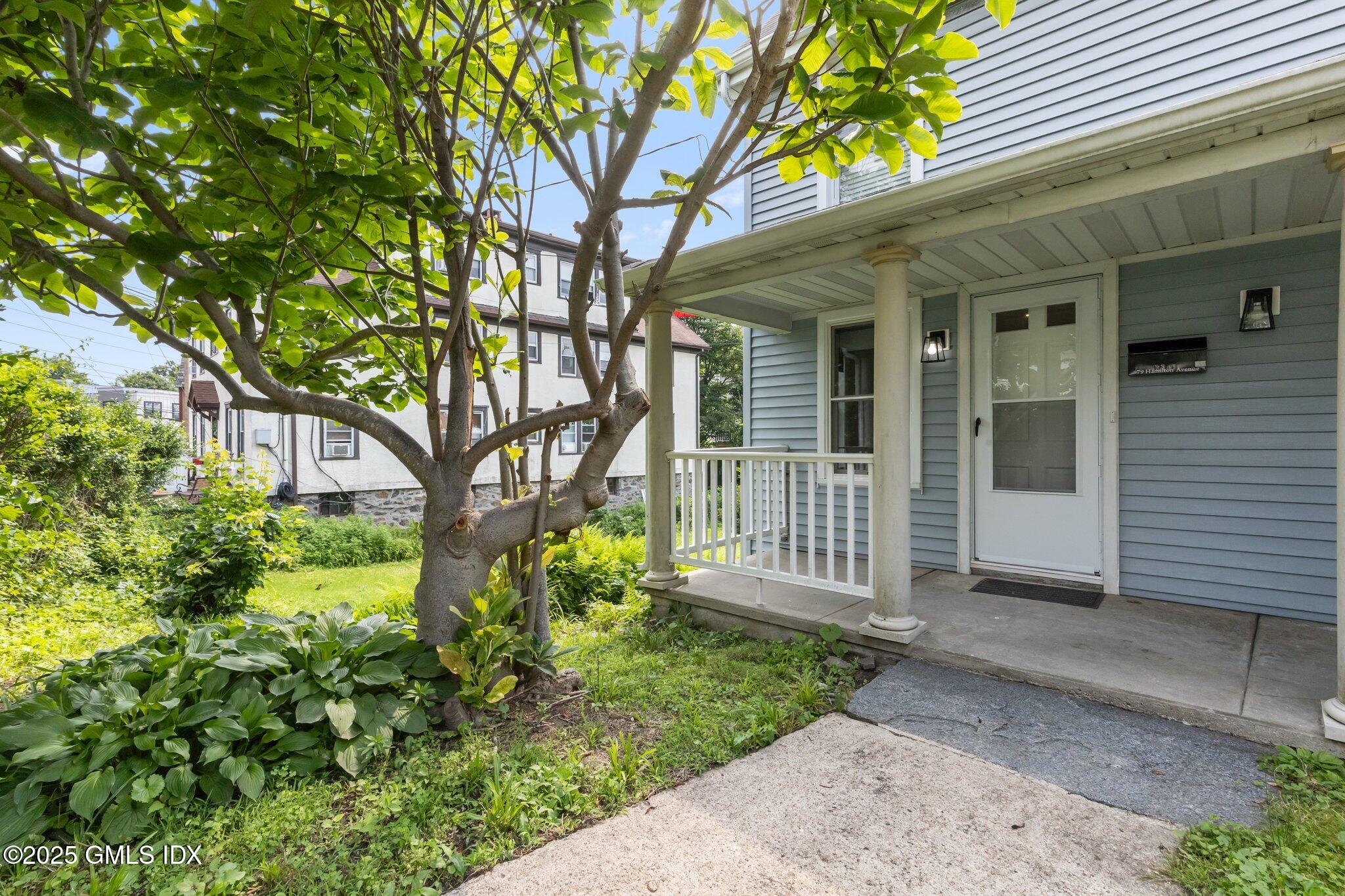 a front view of a house with garden
