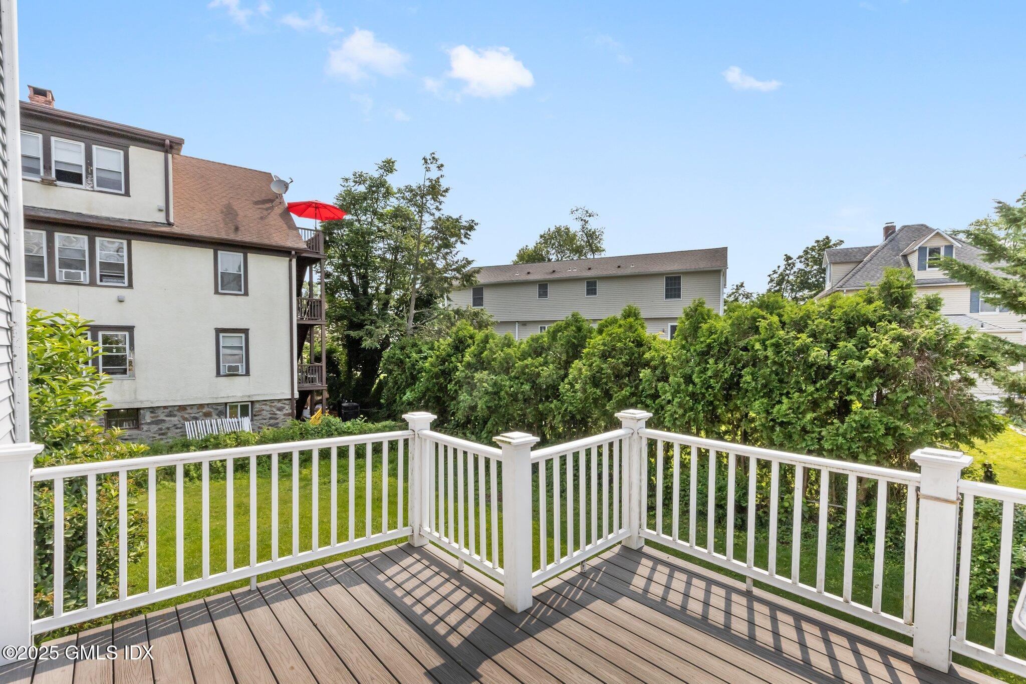 79 Hamilton Avenue, Unit B Greenwich, CT 06830 - Photo 12 of 18 a balcony with wooden floor and fence