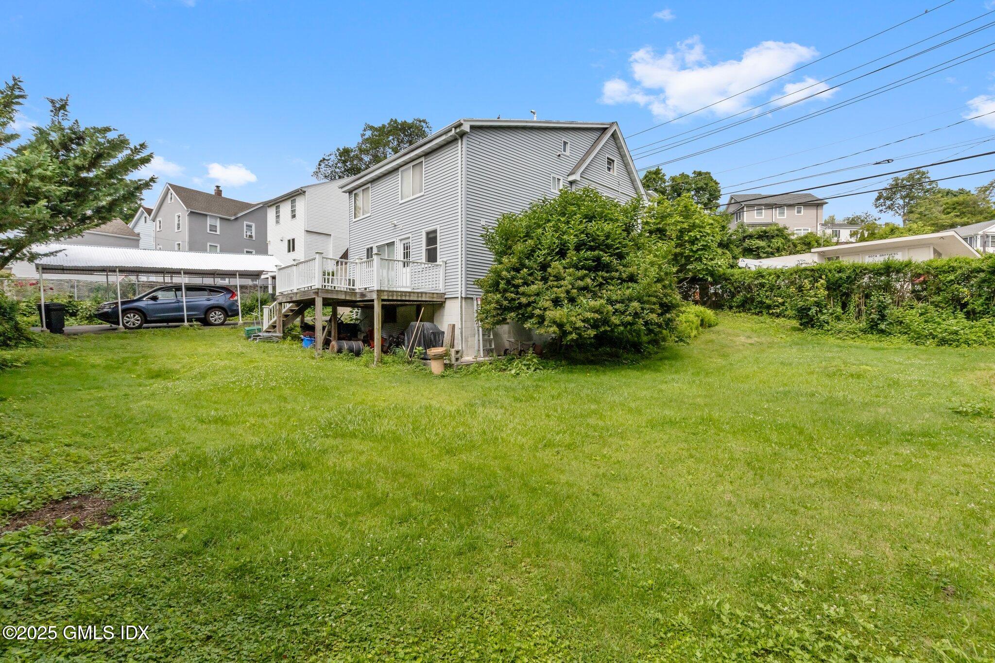 79 Hamilton Avenue, Unit B Greenwich, CT 06830 - Photo 14 of 18 a view of a house with a yard and sitting area