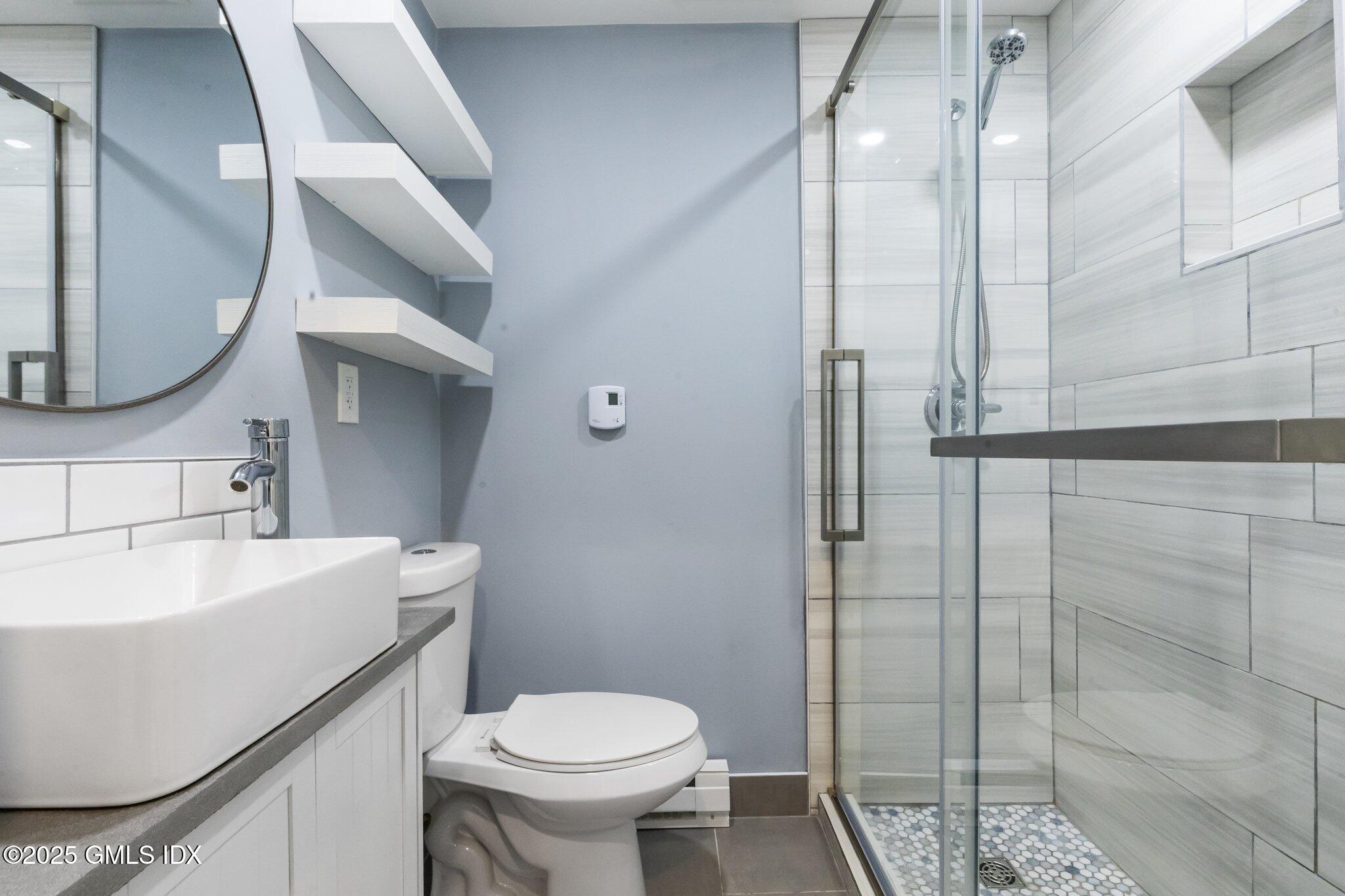 79 Hamilton Avenue, Unit B Greenwich, CT 06830 - Photo 4 of 18 a bathroom with a sink toilet and shower