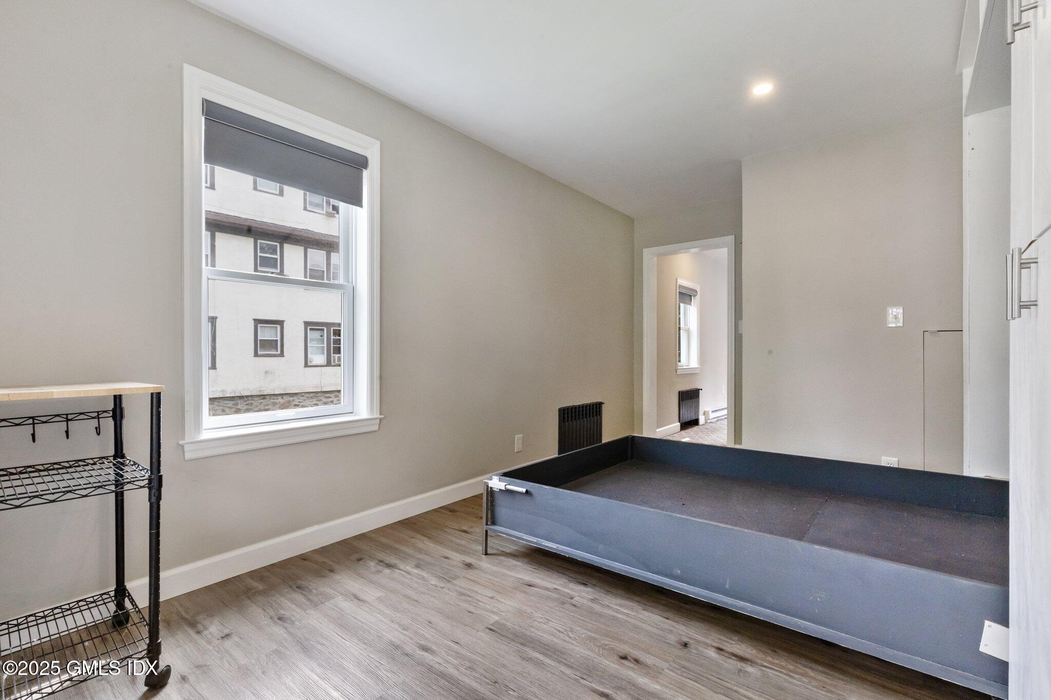 79 Hamilton Avenue, Unit B Greenwich, CT 06830 - Photo 6 of 18 a bedroom with a bed and a window