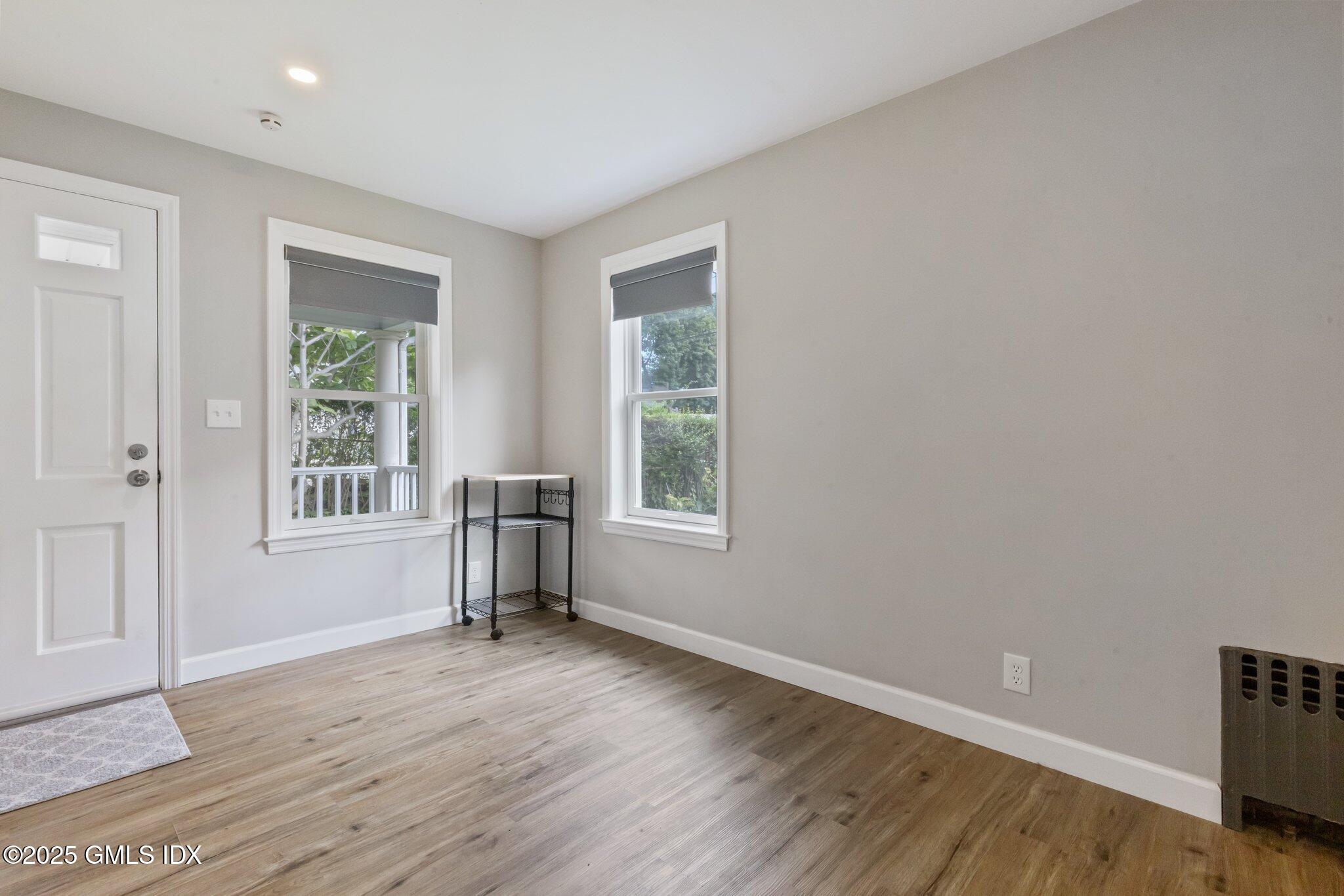 79 Hamilton Avenue, Unit B Greenwich, CT 06830 - Photo 8 of 18 a view of empty room with wooden floor and fan