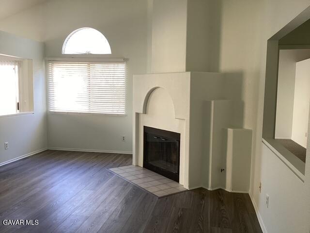 44603 Palm Lane Lancaster, CA 93535 - Photo 2 of 18 an empty room with wooden floor a fireplace and windows