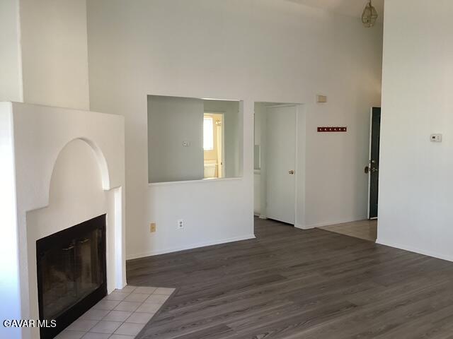 44603 Palm Lane Lancaster, CA 93535 - Photo 4 of 18 an empty room with wooden floor fireplace and windows