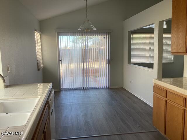 44603 Palm Lane Lancaster, CA 93535 - Photo 6 of 18 a view of a kitchen that shows a sink dishwasher and a dishwasher with wooden floor