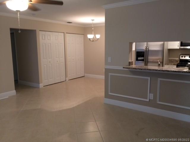 3994 Northwest Cinnamon Tree Circle Jensen Beach, FL 34957 - Photo 7 of 14 a kitchen with stainless steel appliances a refrigerator and a sink