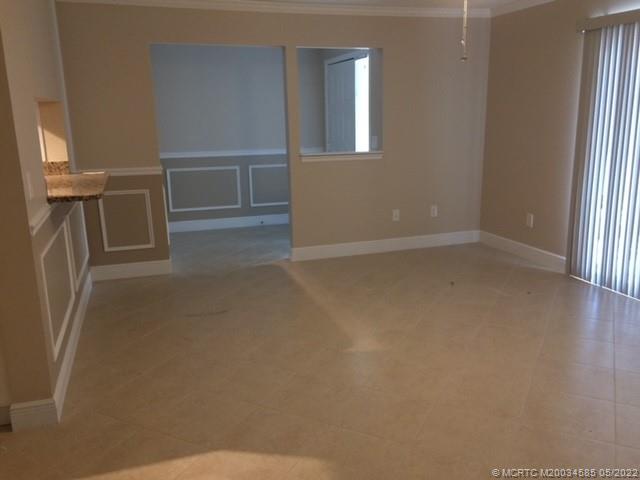 3994 Northwest Cinnamon Tree Circle Jensen Beach, FL 34957 - Photo 10 of 14 a view of an empty room with a window