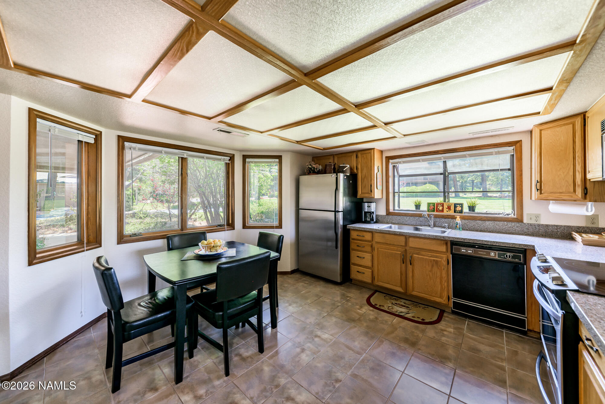 6000 East Laurel Loop, Unit 11 Flagstaff, AZ 86004 - Photo 17 of 54 a kitchen with a table chairs and refrigerator