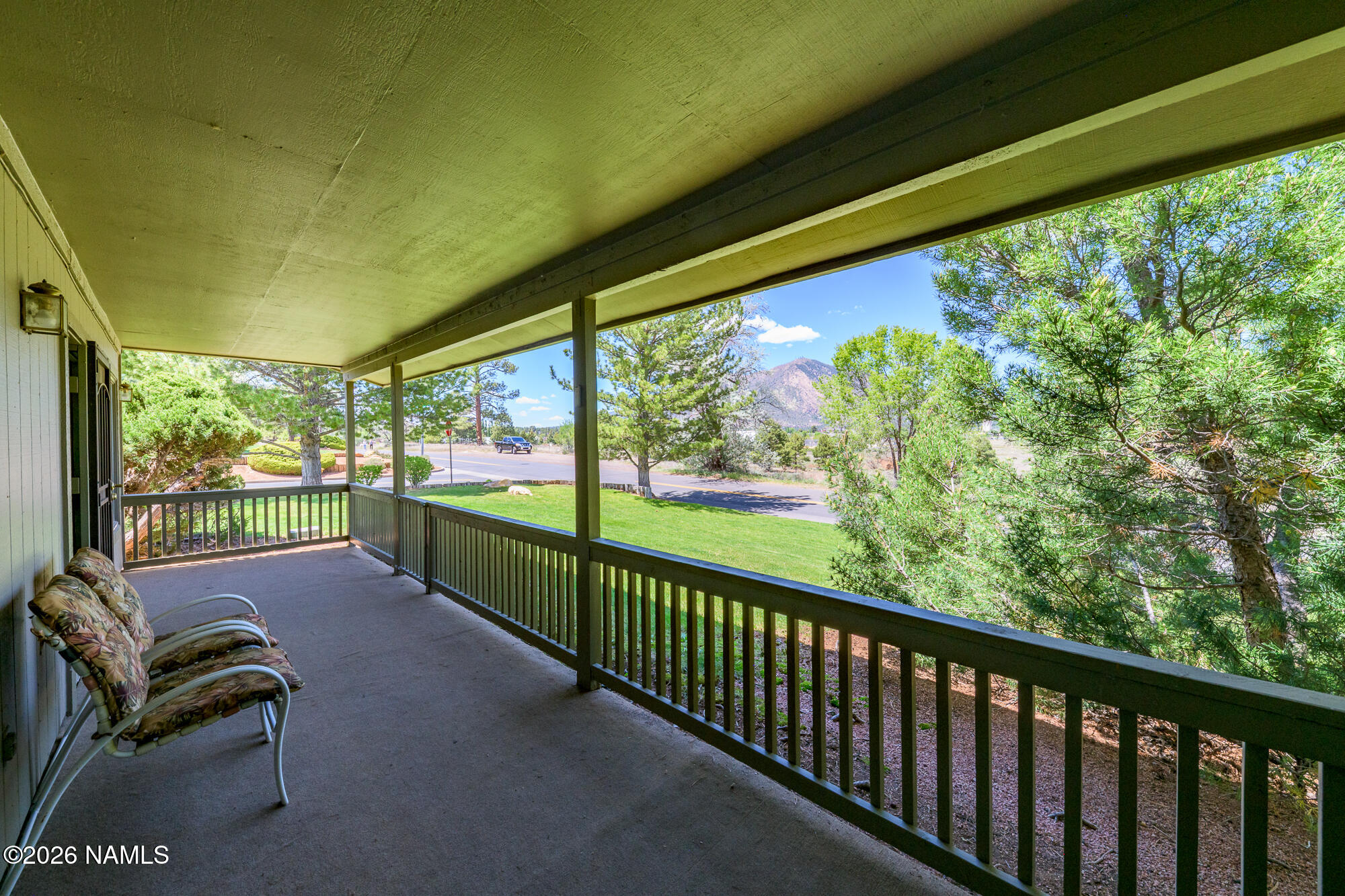 6000 East Laurel Loop, Unit 11 Flagstaff, AZ 86004 - Photo 2 of 54 a view of a porch with furniture and a yard