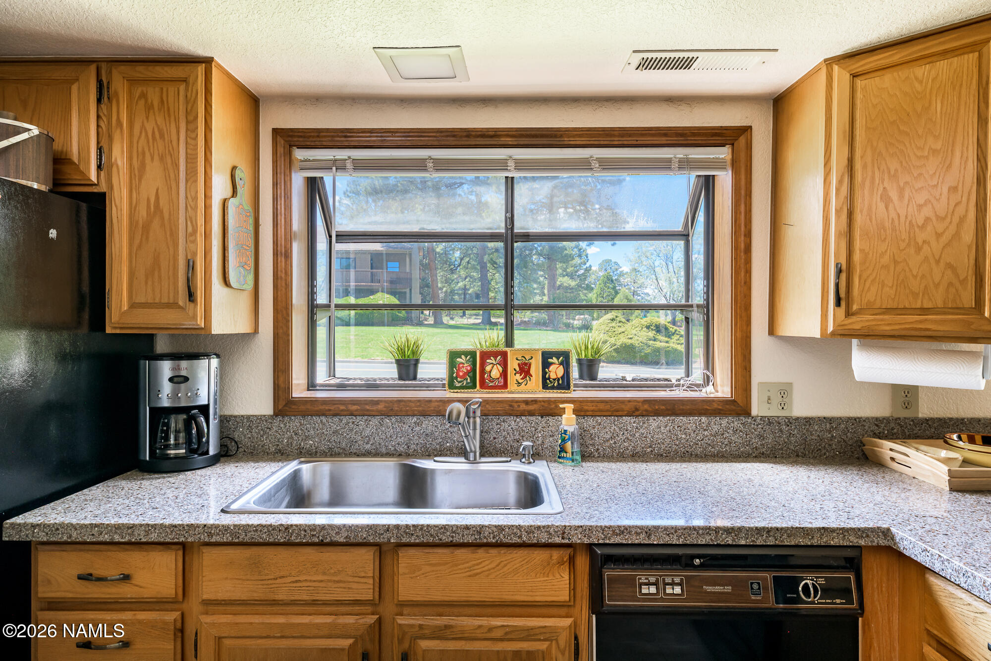 6000 East Laurel Loop, Unit 11 Flagstaff, AZ 86004 - Photo 20 of 54 a kitchen with granite countertop sink and cabinets