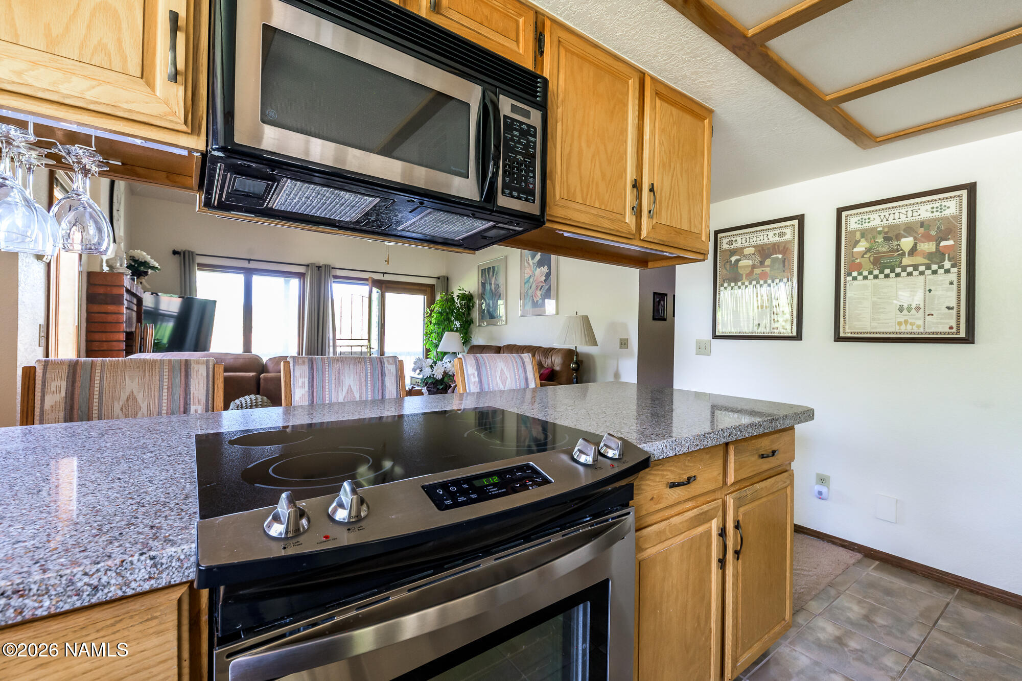 6000 East Laurel Loop, Unit 11 Flagstaff, AZ 86004 - Photo 21 of 54 a kitchen with stainless steel appliances granite countertop a stove and a microwave