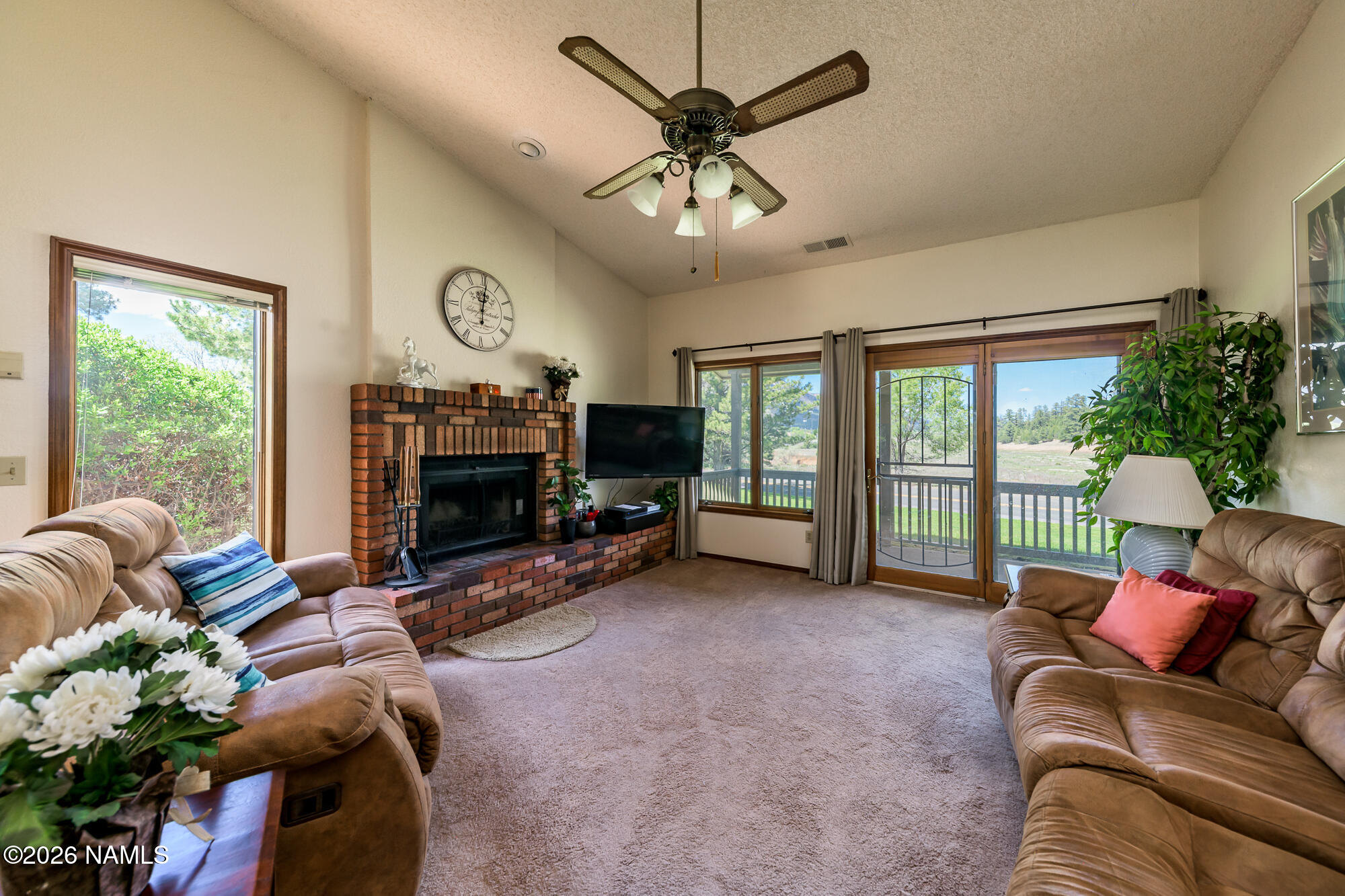 6000 East Laurel Loop, Unit 11 Flagstaff, AZ 86004 - Photo 23 of 54 a living room with furniture a fireplace and a large window
