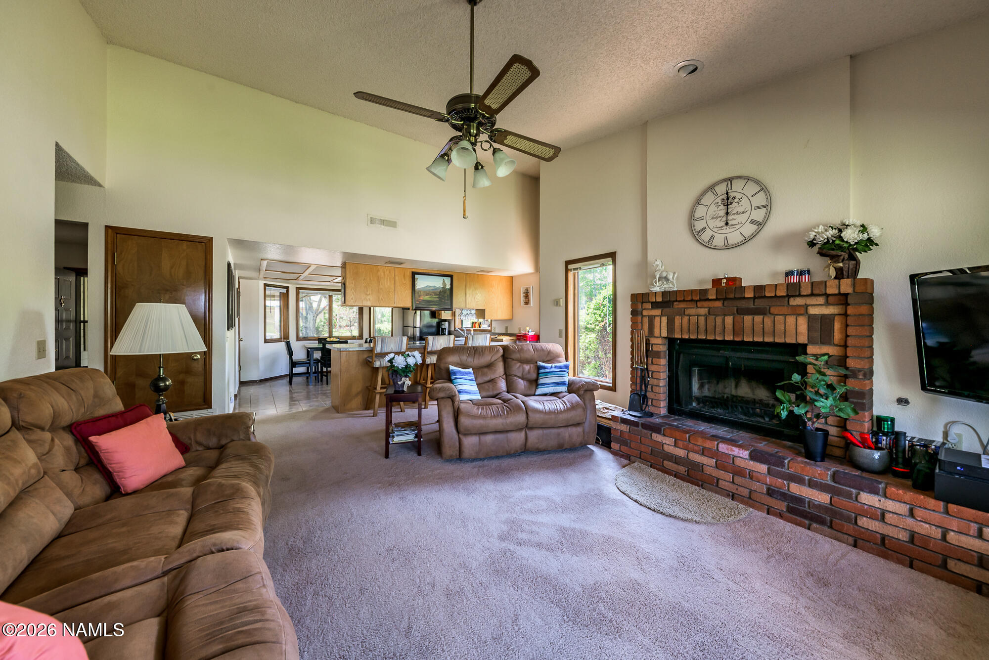6000 East Laurel Loop, Unit 11 Flagstaff, AZ 86004 - Photo 24 of 54 a living room with furniture a fireplace and a flat screen tv