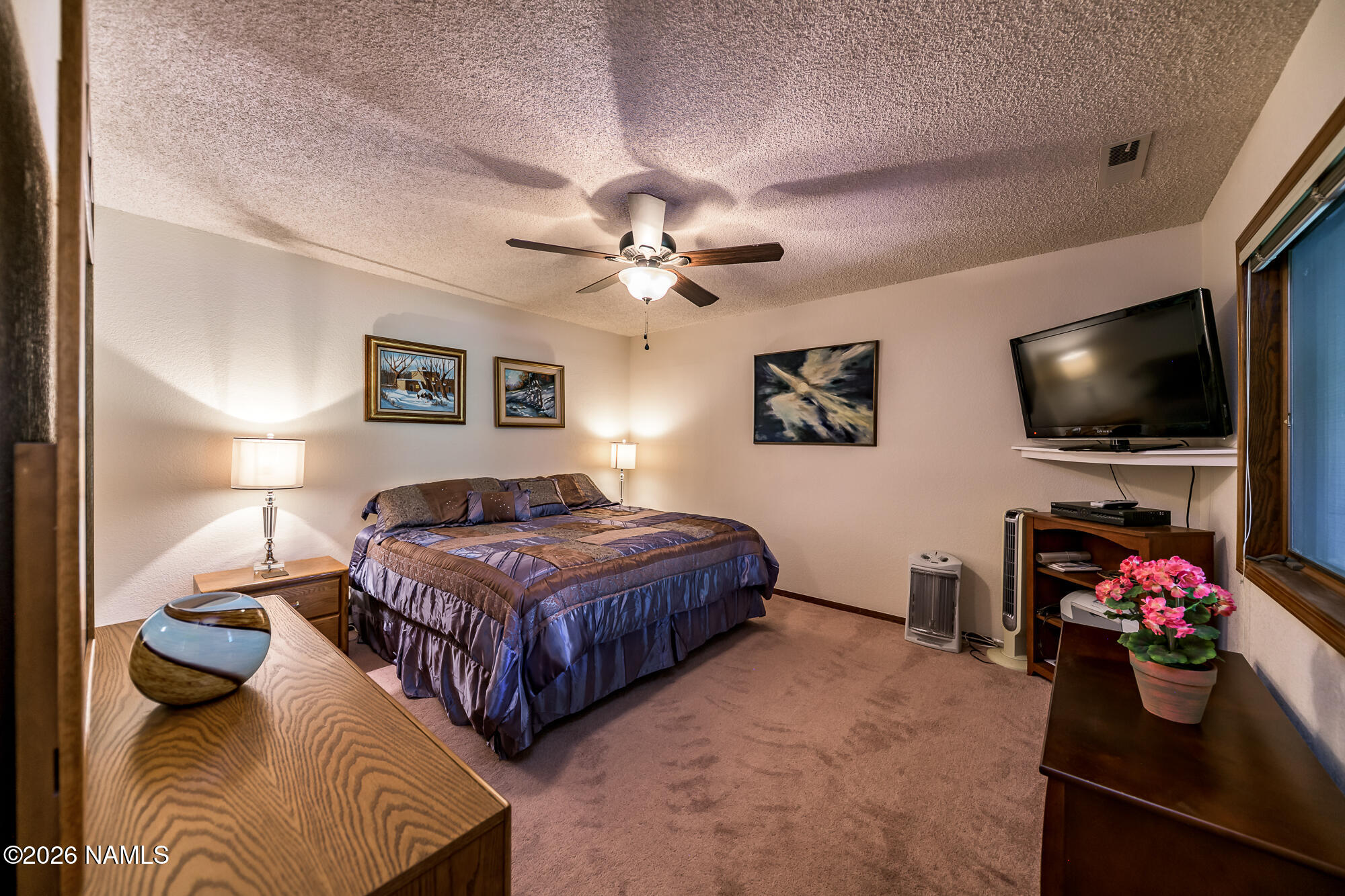 6000 East Laurel Loop, Unit 11 Flagstaff, AZ 86004 - Photo 26 of 54 a bedroom with a bed and a flat screen tv