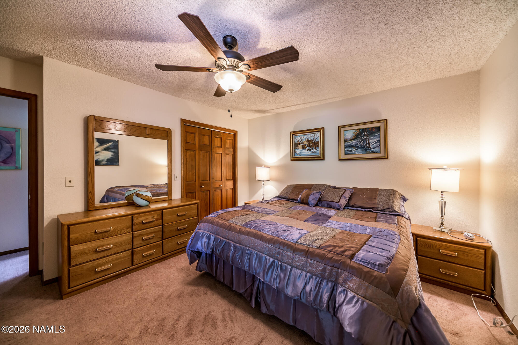 6000 East Laurel Loop, Unit 11 Flagstaff, AZ 86004 - Photo 27 of 54 a bedroom with a bed and a chandelier