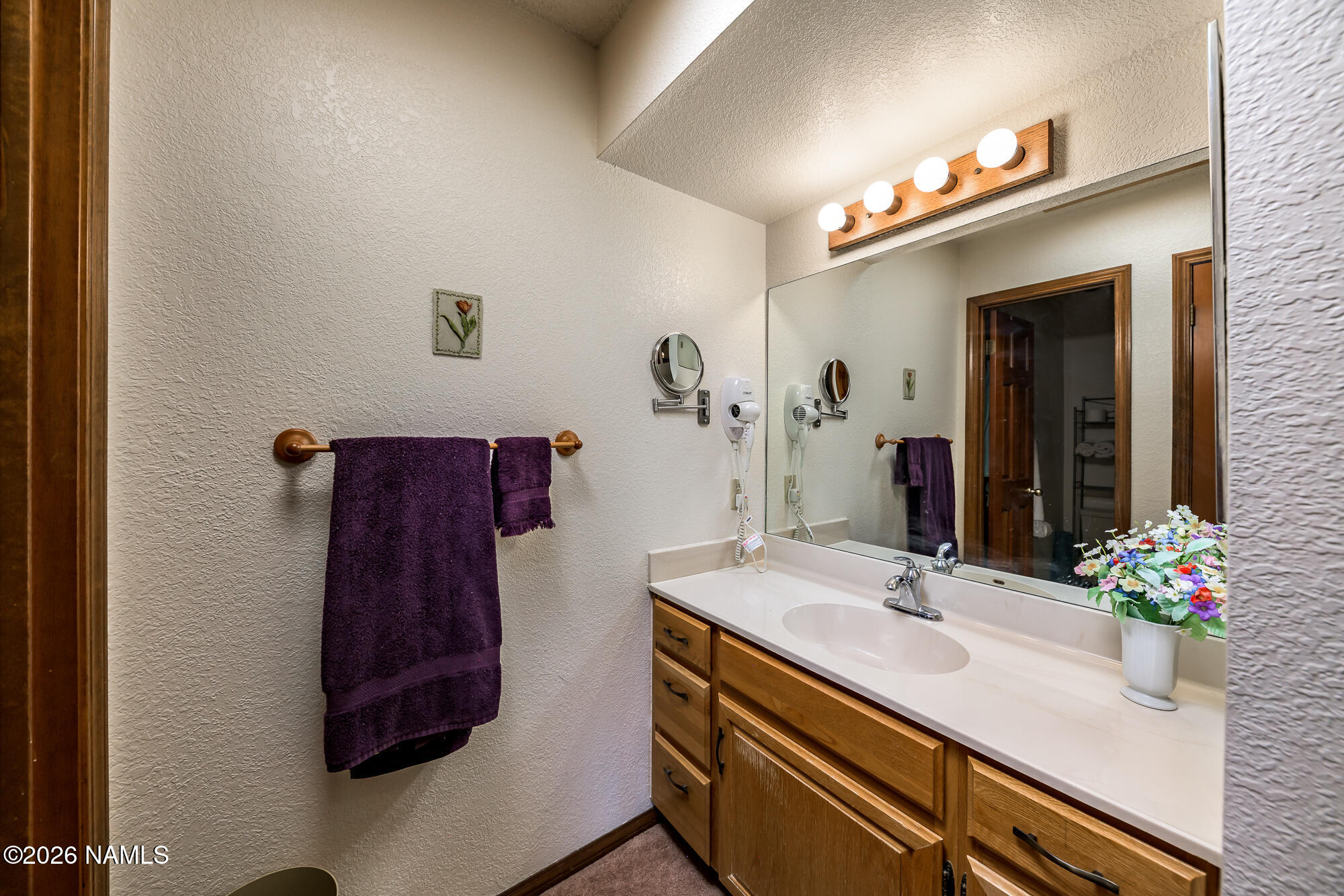 6000 East Laurel Loop, Unit 11 Flagstaff, AZ 86004 - Photo 31 of 54 a bathroom with a sink and a mirror