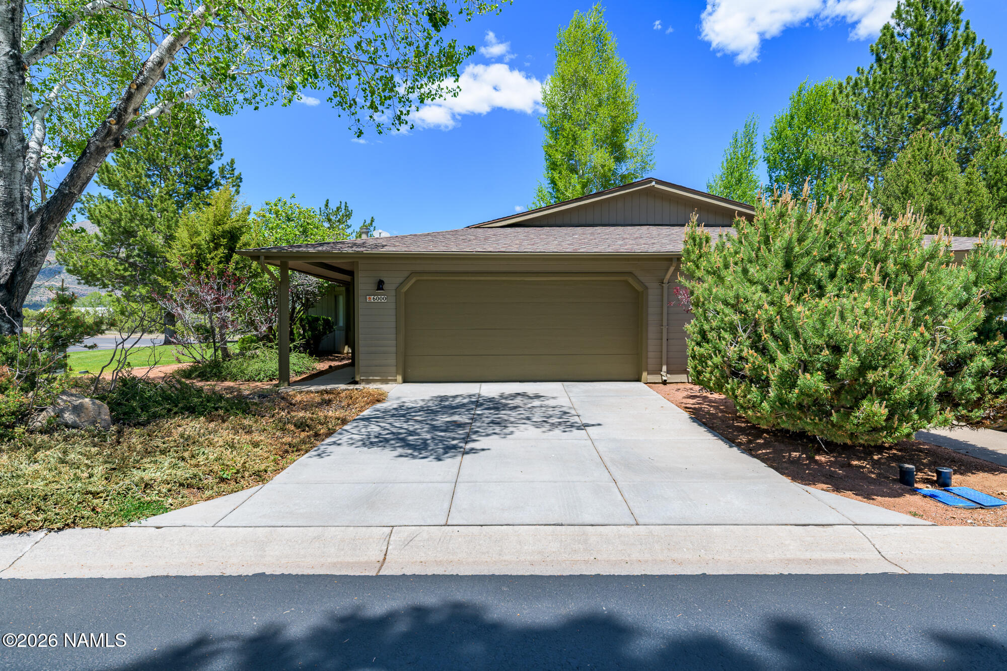 6000 East Laurel Loop, Unit 11 Flagstaff, AZ 86004 - Photo 6 of 54 a front view of a house with a yard and garage