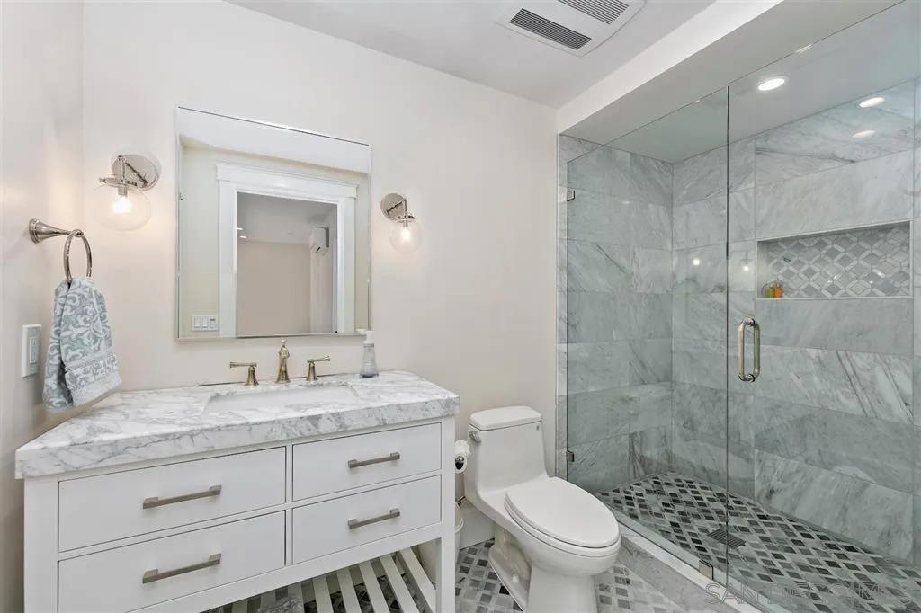 1622 Forest Way Del Mar, CA 92014 - Photo 17 of 25 a bathroom with a granite countertop sink a toilet and a mirror