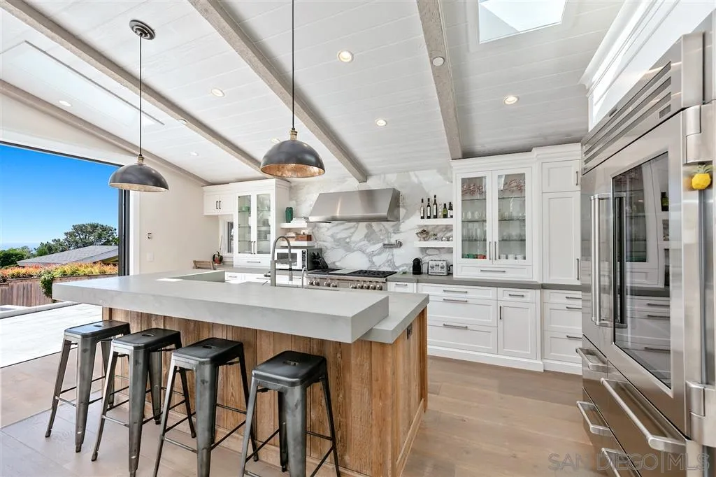 1622 Forest Way Del Mar, CA 92014 - Photo 7 of 25 a kitchen with cabinets a sink stove and chairs