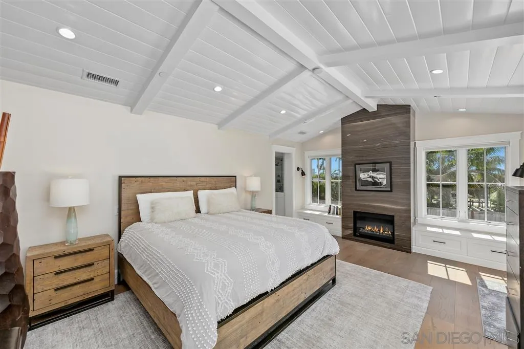 1622 Forest Way Del Mar, CA 92014 - Photo 10 of 25 a spacious bedroom with a bed and a fireplace