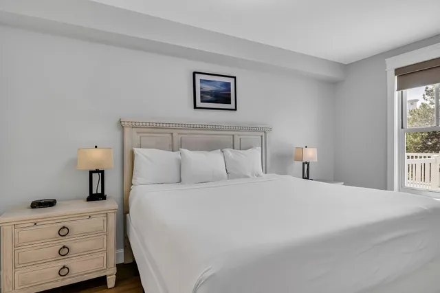 a bedroom with a large bed and a flat screen tv